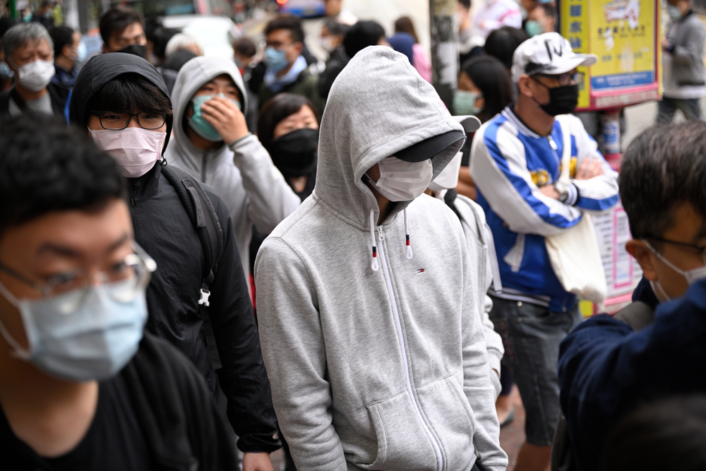 Group of Asian men and women wearing masks.