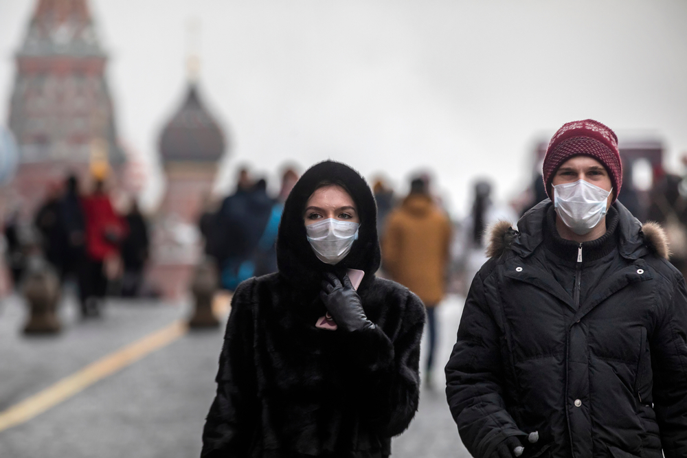 Couple walking through Moscow with masks.